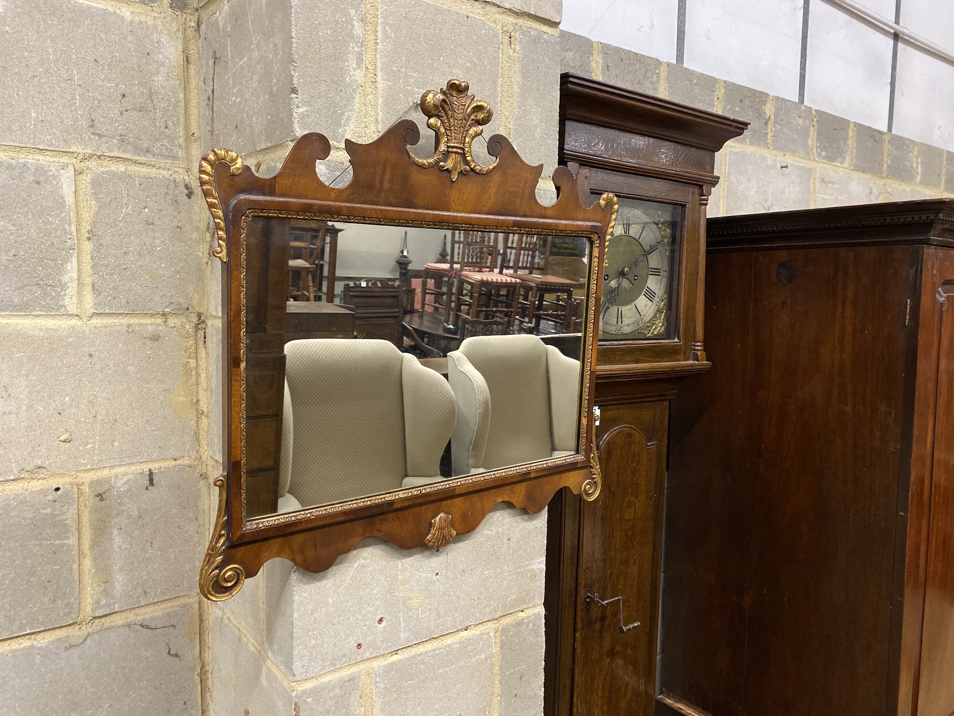 A Queen Anne style parcel gilt fret cut wall mirror, with gilt fleur de lys surmount, together with another, larger mirror width 82cm, height 71cm